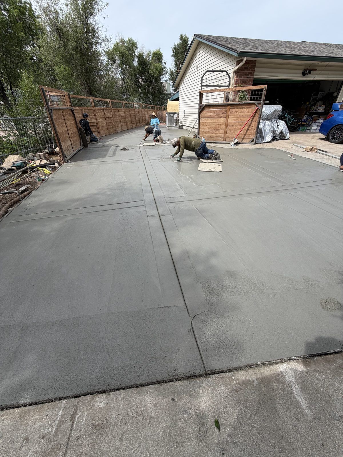 Crew finishing a long driveway