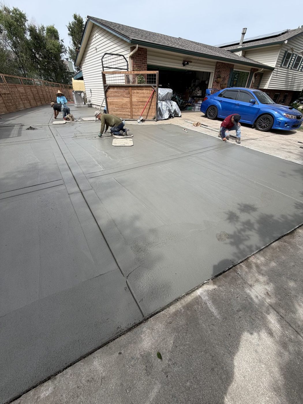 Crew hand-finishing a long driveway