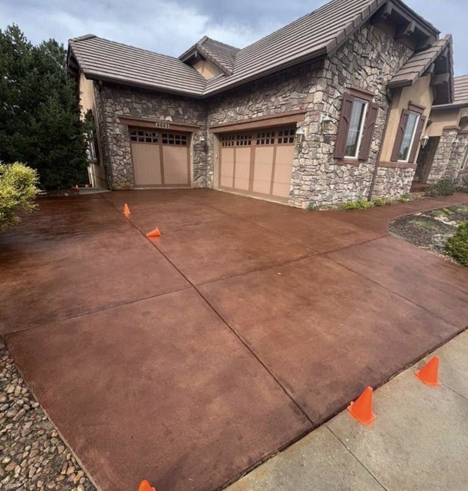 Stained driveway, stone home