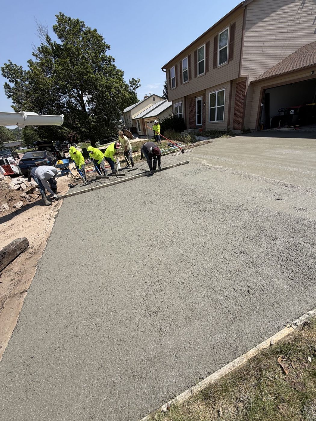 Crew in hi-vis placing a driveway pour