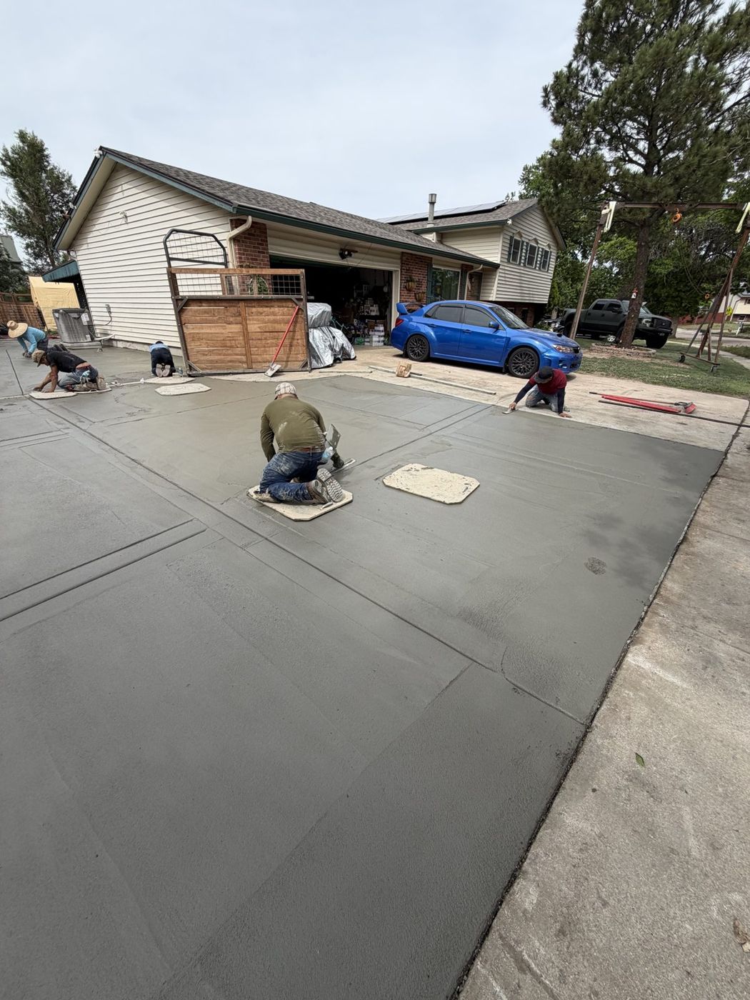 Crew hand-finishing concrete