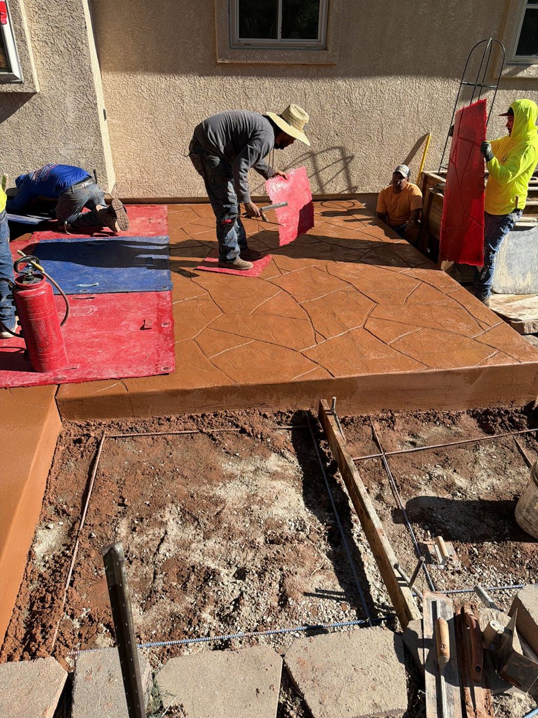Our crew stamping a terracotta patio.