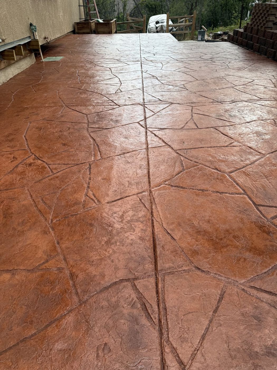 Joint detail on a terracotta stamped patio.