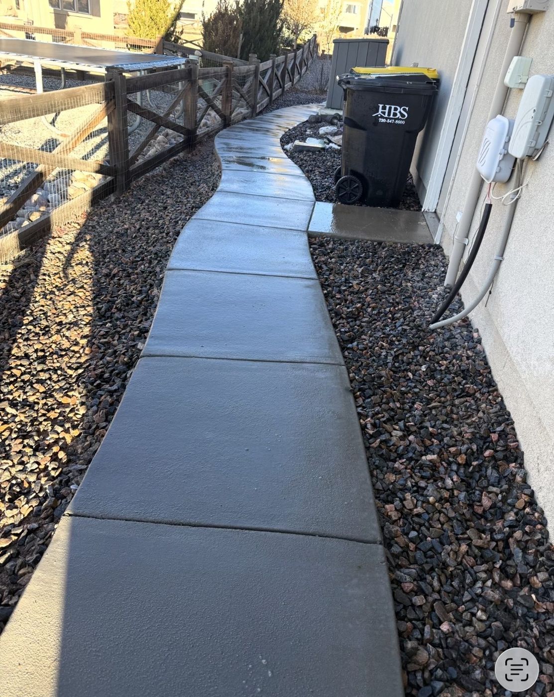 Dark walkway with river-rock border